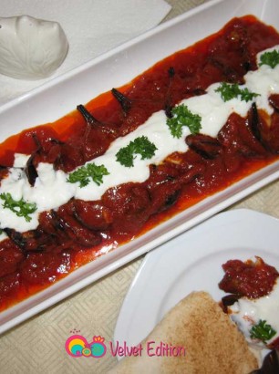 Spoon the garlic yogurt sauce over the top of the eggplants and garnish with chopped parsley if desired.