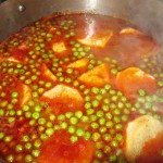 Once the steaks have cooked for an hour, add the potatoes and the peas to the pan.v