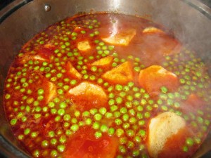 Once the steaks have cooked for an hour, add the potatoes and the peas to the pan.v