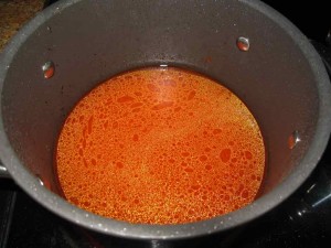 Add 6 cups of water to the tomato and pepper paste. Cover and bring to a boil until the tomato and pepper paste have dissolved thoroughly.