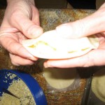 Hold the filled pastry and with one hand secure the edges firmly.