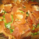 Place the crumbled pita bread over the salad. You can serve it this way to prevent the bread from getting soggy.