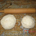Knead to form a dough, and shape into two balls, one slightly larger than the other.