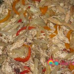 Add the shredded chicken to the onions and bell peppers. Mix all the ingredients together.