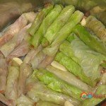 Add another layer of dolmas over the first layer and continue to do so until all the dolmas have been placed.