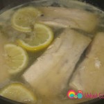 Gently add the poached fish and make sure it's completely submerged in the broth.