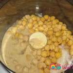 Add the peeled chickpeas, tahini, lemon juice, garbanzo beans juice and salt in the processor.