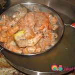 Place a sieve over a large bowl and gently pour the broth in.