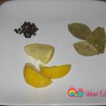 Prepare 1 teaspoon black peppercorns, lemon wedges and bay leaves.