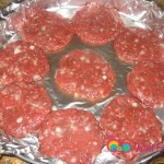 Grab a handful of the meat mixture and form into a patty. Place the patties side by side in the pan. Rub both sides of the patty with oil.
