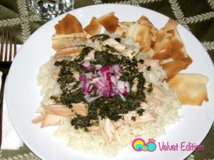 Serve with the rice on the bottom, shredded chicken on top, then the mloukhiyeh mixture, and finally a spoonful of the onion vinegar on the very top. Add toasted pita bread on the side.