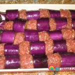 Place the skewers into the greased baking pan. Drizzle the water, oil, and salt mixture over it.