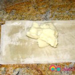 Add a tablespoon of the cold cream on one end of the dough.