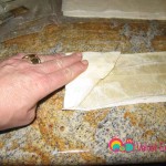 Continue with the folding the same way until you reach the other side. Tuck any remaining pieces under. It will look like a samosa.