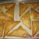 Bake till golden brown, about 25 to 30 minutes. Serve warm with syrup and ground pistachios.