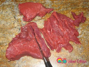 Trim the steaks by removing the fat and cutting the meat across the grain.