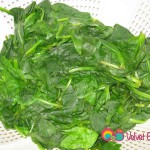 Steam the spinach in salted boiling water, remove and drain in colander.