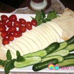 Halloumi cheese served with cucumbers, tomatoes, mint and pita bread.