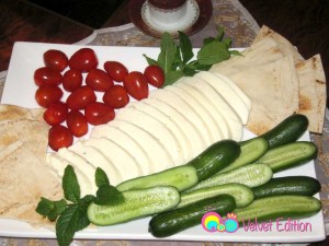 Halloumi cheese served with cucumbers, tomatoes, mint and pita bread.