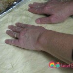 Carefully transfer the dough to the greased baking pan and make sure you cover the edges of the pan.