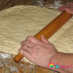 On a lightly floured surface and a rolling pin start to shape the dough.