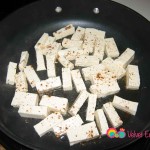 Add the tofu to a skillet with the peanut oil. Sprinkle with some of the Chinese 5 spice seasoning.