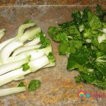 Chop the bok choy and separate the green leaves from the white ends.