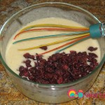 Add the dried raisins or cranberries to the dressing.