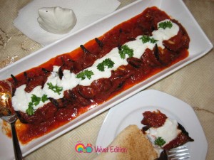 Spoon the garlic yogurt sauce over the top of the eggplants and garnish with chopped parsley if desired.