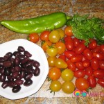 Chop the Anaheim pepper, cherry tomatoes, Kalamata olives, and basil leaves.