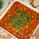 Classic Armenian plaki salad, drizzled with olive oil and garnished with parsley.