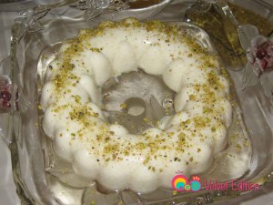 Cream of wheat and coconut pudding drizzled with syrup and ground pistachios.