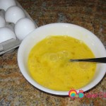 Using a fork, whisk the eggs and add the milk.